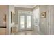 Bright entryway featuring frosted glass double doors, neutral walls, and elegant tile flooring at 4612 4Th E Ave, Bradenton, FL 34208