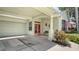 Covered front porch with double doors, well-maintained landscaping, and access to garage at 4612 4Th E Ave, Bradenton, FL 34208