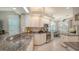Bright kitchen featuring granite countertops, white cabinetry, and stainless steel appliances at 4612 4Th E Ave, Bradenton, FL 34208