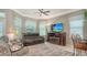 Comfortable living room with an electric fireplace, ceiling fan, and ample seating at 4612 4Th E Ave, Bradenton, FL 34208