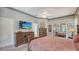 Spacious main bedroom featuring a ceiling fan, dresser with television, and a large, mirrored closet at 4612 4Th E Ave, Bradenton, FL 34208