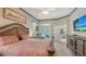 Bright main bedroom with access to the pool area, featuring a decorative headboard and comfortable furnishings at 4612 4Th E Ave, Bradenton, FL 34208