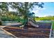 Community playground featuring a modern playset, slides, and mulch ground cover at 4612 4Th E Ave, Bradenton, FL 34208