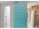 Bathroom featuring stylish turquoise sliding door, shower, and white door to toilet area at 4629 Whirlaway Dr # B, Sarasota, FL 34233