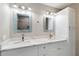 Bathroom with dual sinks, sleek countertops, modern fixtures, and beautiful mirrors at 4629 Whirlaway Dr # B, Sarasota, FL 34233