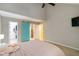 Bedroom featuring walk in closet, en suite bathroom, and brightly colored sliding door at 4629 Whirlaway Dr # B, Sarasota, FL 34233