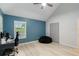 Bedroom featuring wood floors, a ceiling fan, and natural light at 4629 Whirlaway Dr # B, Sarasota, FL 34233