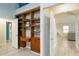 Bedroom featuring open shelving with attached desk, and doorway to the hallway at 4629 Whirlaway Dr # B, Sarasota, FL 34233