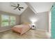 Bedroom with a ceiling fan, window with blinds, and an adjacent doorway at 4629 Whirlaway Dr # B, Sarasota, FL 34233