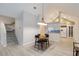 Open-concept dining area with vaulted ceiling connects to the kitchen and stairs, featuring light wood-look floors at 4629 Whirlaway Dr # B, Sarasota, FL 34233