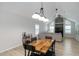 Open dining room with vaulted ceiling, modern table, and view of the living area at 4629 Whirlaway Dr # B, Sarasota, FL 34233