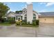 Charming home featuring arched windows, a well-manicured lawn, and a two-car garage at 4629 Whirlaway Dr # B, Sarasota, FL 34233