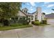 Charming home featuring arched windows, a well-manicured lawn, and a two-car garage at 4629 Whirlaway Dr # B, Sarasota, FL 34233