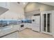 Bright kitchen with white appliances, granite countertops, and pantry closet at 4629 Whirlaway Dr # B, Sarasota, FL 34233