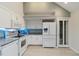Bright kitchen with white appliances, granite countertops, and pantry closet at 4629 Whirlaway Dr # B, Sarasota, FL 34233