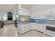 Modern kitchen with vaulted ceiling, granite countertops, and view of the dining area at 4629 Whirlaway Dr # B, Sarasota, FL 34233