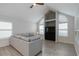 Bright living room with vaulted ceilings, light gray sofa, and arched windows at 4629 Whirlaway Dr # B, Sarasota, FL 34233