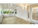 Bright sunroom with tile floors, multiple windows, ceiling fan and decorative front door at 4629 Whirlaway Dr # B, Sarasota, FL 34233