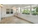 Bright sunroom featuring tile floors, multiple windows, and decorative front door at 4629 Whirlaway Dr # B, Sarasota, FL 34233