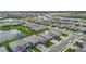 Serene aerial view of single-Gathering homes nestled around a tranquil lake, surrounded by lush green spaces at 4971 Oyster Pearl St, Bradenton, FL 34211