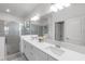 Modern bathroom with double sinks, a large mirror, and a glass-enclosed shower at 4971 Oyster Pearl St, Bradenton, FL 34211