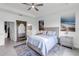 Comfortable bedroom with a large mirror, blue accents, and ensuite access to the bathroom at 4971 Oyster Pearl St, Bradenton, FL 34211