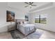 Serene bedroom featuring a large window with a view, neutral tones, and stylish furnishings at 4971 Oyster Pearl St, Bradenton, FL 34211