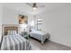 Bright bedroom features stylish twin beds with striped bedding, complemented by a beach-themed art and side table at 4971 Oyster Pearl St, Bradenton, FL 34211