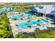 Aerial view showcasing the community pool area with palm trees, seating, and well-maintained grounds at 4971 Oyster Pearl St, Bradenton, FL 34211