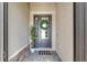 Covered entry with sidelight, wreath, potted plant, and 'Welcome' mat at 4971 Oyster Pearl St, Bradenton, FL 34211