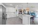 Bright white kitchen flows seamlessly into the adjacent living room at 4971 Oyster Pearl St, Bradenton, FL 34211
