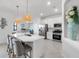 Bright white kitchen features stainless appliances and a large center island with seating at 4971 Oyster Pearl St, Bradenton, FL 34211