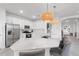 Bright white kitchen features stainless appliances, a large island with bar seating, and stylish pendant lighting at 4971 Oyster Pearl St, Bradenton, FL 34211