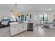 Bright white kitchen with an island connects to a dining area and the living room at 4971 Oyster Pearl St, Bradenton, FL 34211