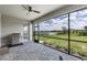 Covered patio with a grill, brick flooring, and serene views of the backyard and lake at 4971 Oyster Pearl St, Bradenton, FL 34211
