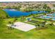 Aerial view of community recreation area with beach volleyball, bocce ball, pool and lake at 4971 Oyster Pearl St, Bradenton, FL 34211
