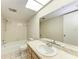 Bright bathroom with tile flooring, a tub, and a white marble vanity at 5109 28Th W St, Bradenton, FL 34207