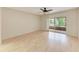 Spacious bedroom with wood floors and sliding door to sunroom at 5109 28Th W St, Bradenton, FL 34207