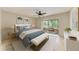 Cozy bedroom featuring a ceiling fan, calming decor, and a sliding glass door to an outdoor space at 5109 28Th W St, Bradenton, FL 34207