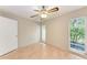 Bedroom features wood-look flooring, windows overlooking greenery, and overhead fan at 5109 28Th W St, Bradenton, FL 34207