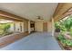 Spacious carport featuring a ceiling fan, storage room, and adjacent landscaped garden at 5109 28Th W St, Bradenton, FL 34207