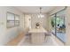 Bright dining area showcasing a wooden table, decor, and sliding door access to outdoor space at 5109 28Th W St, Bradenton, FL 34207