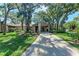Charming home exterior with mature trees and lush landscaping creating a serene and inviting atmosphere at 5109 28Th W St, Bradenton, FL 34207