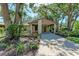 Inviting home exterior showcasing the carport, beautiful trees, and lush landscaping at 5109 28Th W St, Bradenton, FL 34207