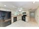 Classic kitchen with white cabinets, black appliances, and tile flooring at 5109 28Th W St, Bradenton, FL 34207