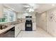 Well-lit kitchen featuring neutral cabinets, tile flooring, and a ceiling fan at 5109 28Th W St, Bradenton, FL 34207