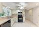 Bright kitchen features tile floors, white cabinetry, and modern black appliances at 5109 28Th W St, Bradenton, FL 34207