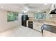 Functional kitchen featuring updated appliances, neutral cabinets, and tile floors at 5109 28Th W St, Bradenton, FL 34207