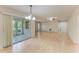 Open floor plan with wood floors, offering ample natural light and access to the sunroom at 5109 28Th W St, Bradenton, FL 34207