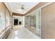 Sunroom featuring tiled floor, wood panel siding, and sliding glass doors to kitchen at 5109 28Th W St, Bradenton, FL 34207
